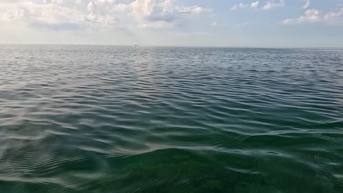 Ocean Sea Water Calm A View of Calm Ocean Water with Cloudy Sky in the Background