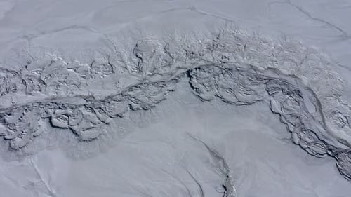 Aerial view of gray abstract mud patterns and cracks on acid mine drainage surface