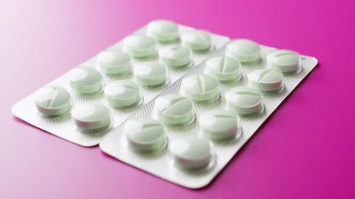 Pills in Blister Pack on Pink Background