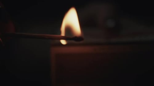 Burning Matchstick Providing Light in Dark Room