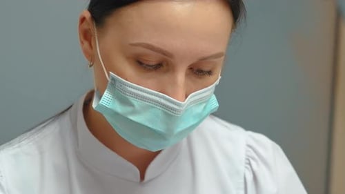 Medical Professional Wearing Surgical Mask and White Coat