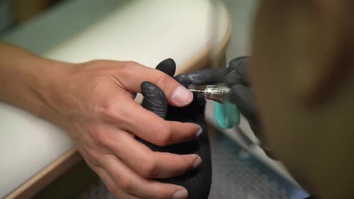 Closeup Top View of Female Beautician Uses Electric Drill to Grinding Polishing and Removing