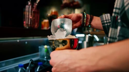 Bartender Filling Gold Cup with Ice