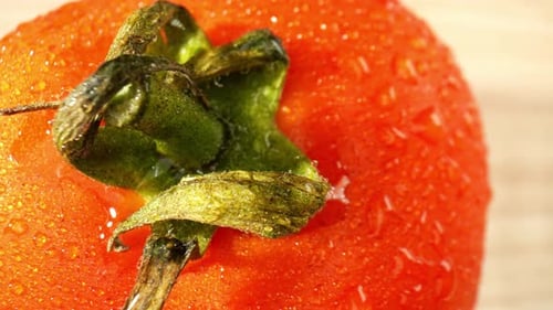A macro video featuring a tomato with droplets of water