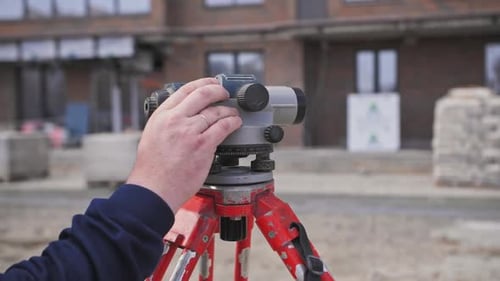Leveling on the Construction Site in the Hands of the Engineer