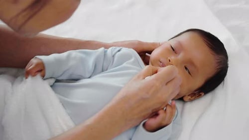 Infant Getting Nose Cleaned with Cotton Swab