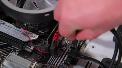 Hands Assemble Data Link to Mother Board in PC