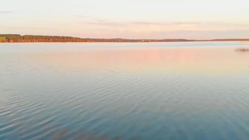 Scenic golden hour ripples of Jugla lake Riga Latvia aerial