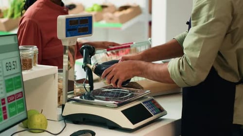Man Weighing Vegetables at Grocery Store Counter