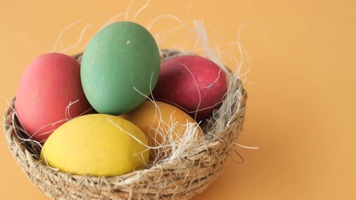 Colorful Easter Eggs in a Decorative Basket on a Bright Background
