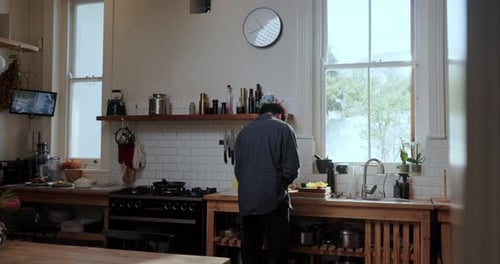 Man preparing food at kitchen counter indoors