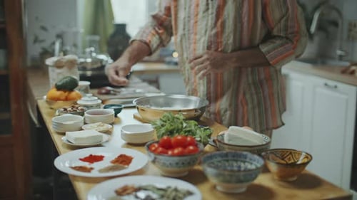 Man Wearing Turban Prepares Food in Kitchen