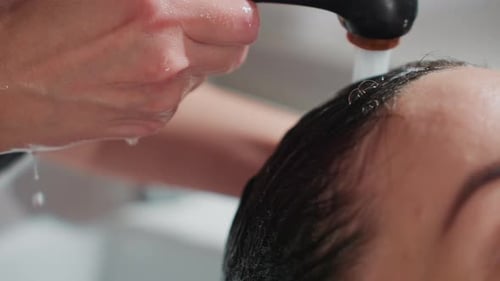Woman Getting her Hair Washed at Hair Salon