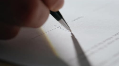 Closeup Hand Signing Document in Office Desk Businessman Putting Signature