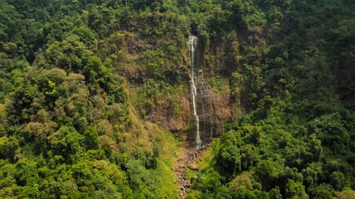 Drone view of Diamante waterfall cascading through lush jungle in Costa Rica