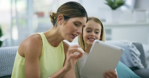 Woman and Girl Using a Tablet Inside Home