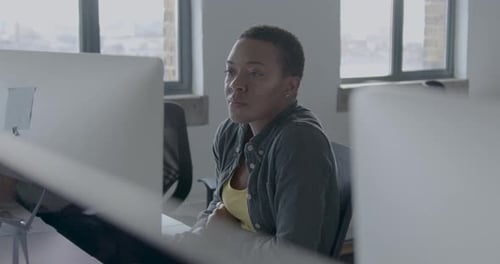 Young African American Businesswoman Working at a Desktop computer in an Office