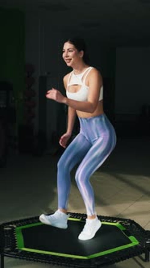 Woman Exercising on Mini Trampoline at the Gym
