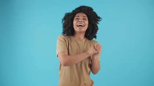 Cheerful Woman Dancing Energetically on Blue Background