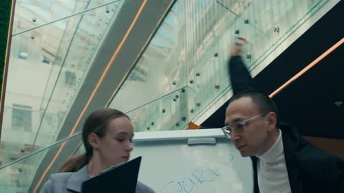Office Colleagues Dancing in front of Whiteboard at Workplace