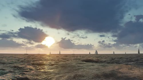 Ocean Sunset with Dynamic Waves and Sailboats