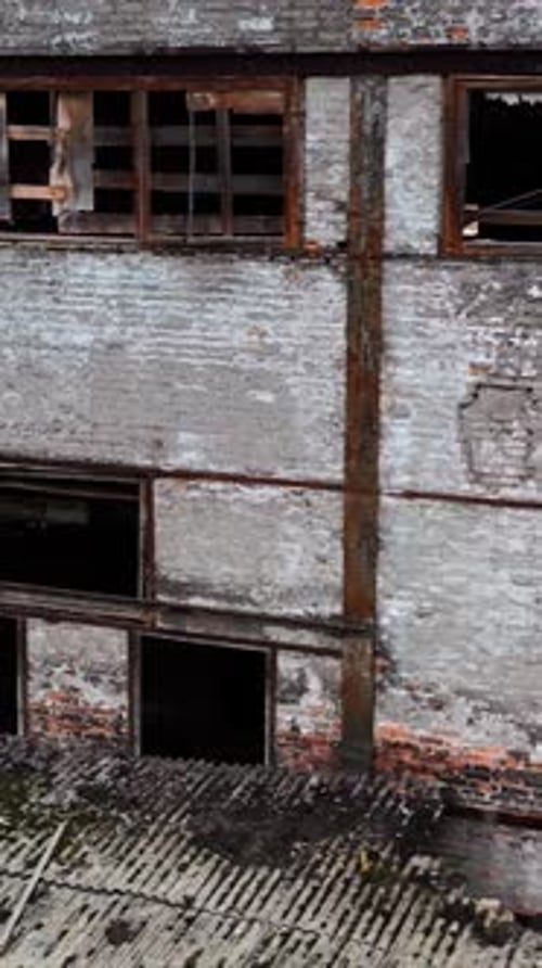 Damaged building with broken windows. Abandoned place after the war.
