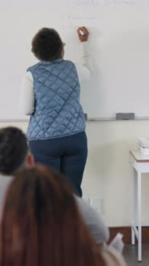 Teacher Writes Study Methods on Whiteboard in Classroom