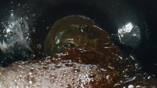 Splashing Fizzy Ale Glassware Closeup. Refreshing Effervescing Beer Stream Swashing Foaming Macro