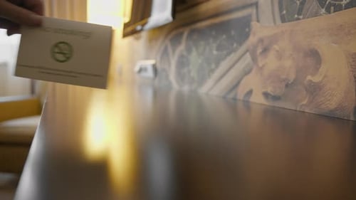 hotel housekeeping worker puts a no smoking sign in hotel room for guests hospitality concept