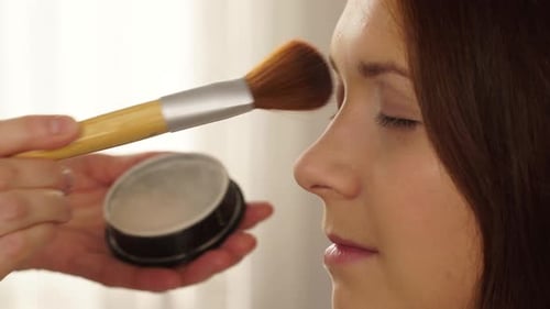 Woman Receiving Powder Makeup Application, Close-Up