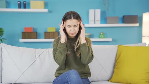 Young girl with headache suffers from pain.