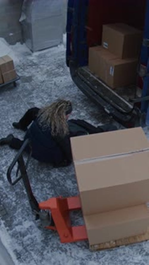 Male Porter Falls Hard on Ice While Unloading Parcels From Van and Cannot Stand