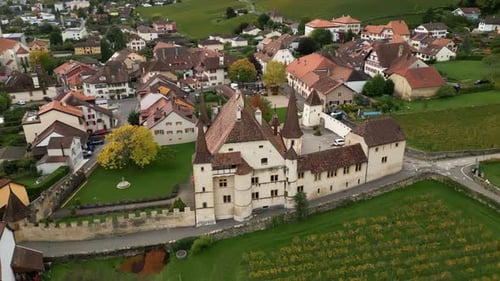 Orbit drone shot of Cressier castle and vineyards