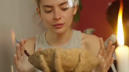 Beautiful Girl Doing Manual Work with Clay in Ceramic Workshop
