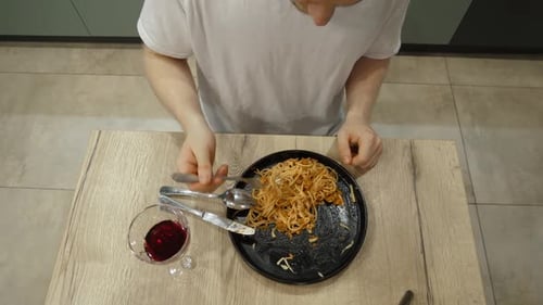 Young Man Eating Delicious Pasta