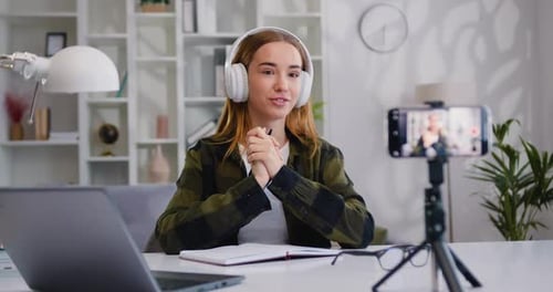 Young Woman is Live Streaming a Training Blog at Home. Chat Online with Channel Subscribers.