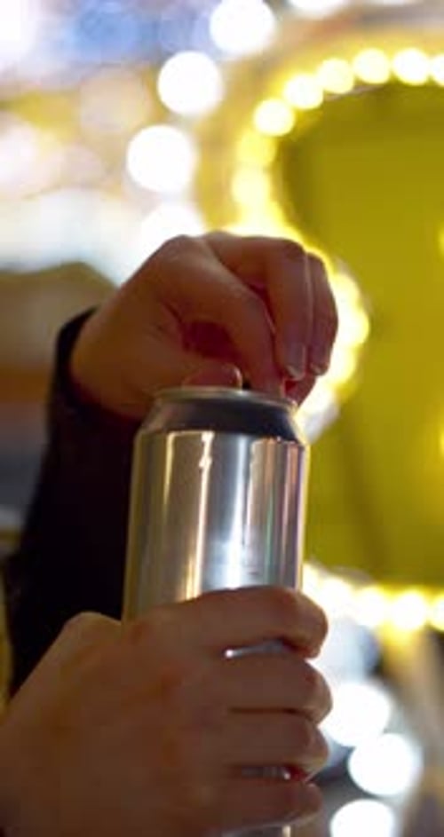 Closeup of Female Hands Opening an Aluminum Can with an Energy Drink