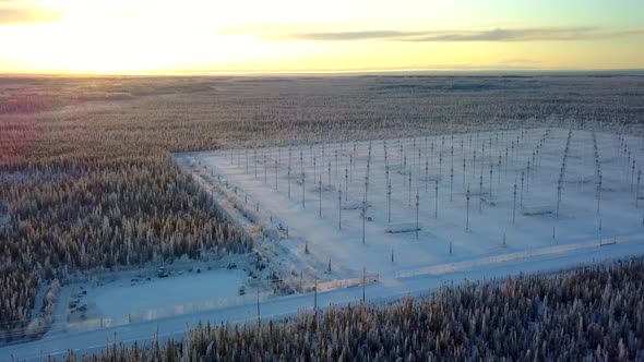 Aerial, pan, drone shot, of the HAARP antenna array, in middle of ...
