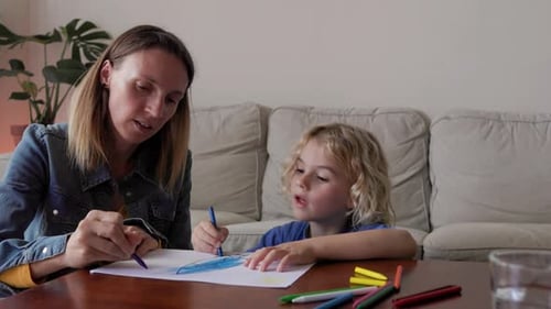 Mother and Child Drawing Together at Table