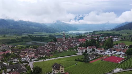 Caldaro Town And Fields With Mountain Views In Italy. - aerial shot