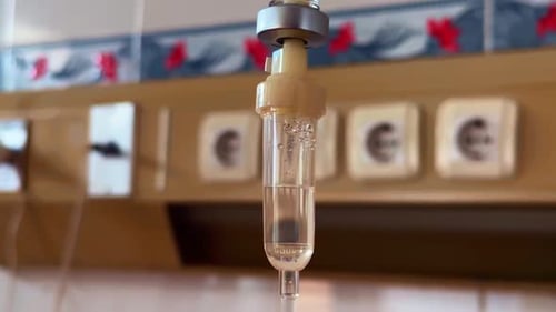 The drop counter of a medical infusion in close up.