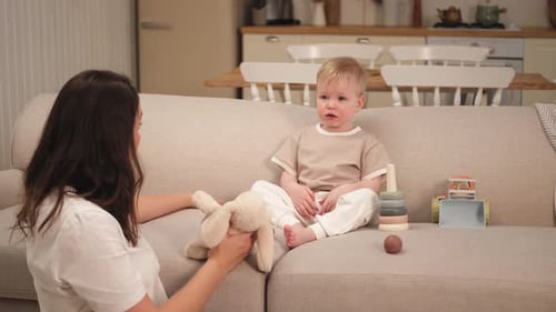 Mother Playing with Her Child and Toys Indoors