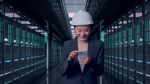Asian Businesswoman Use Smartphone While Walking in Data Center