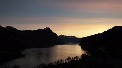 Sunset glow on Walensee, Churfirsten silhouette. Swiss alps