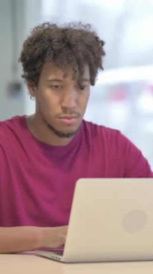 Busy African Man Typing on Laptop in Office, Vertical Video