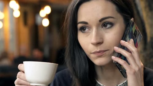 Elegant, Happy Woman Talking on Cellphone and Drinking Coffee in Cafe 30s