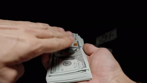 POV Male Hands Scattering Hundred-Dollar Bills, Money Wasted, Uncontrolled Spending.