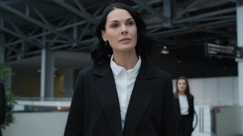 Business Woman Walking Confidently Through Airport Terminal