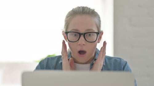 Close Up of Young Woman Reacting to Loss on Laptop
