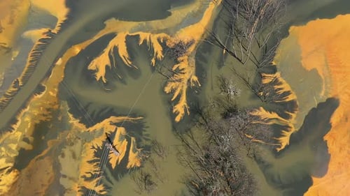 Abstract aerial view of colorful acid mine water drainage in decanting lake. Natural background